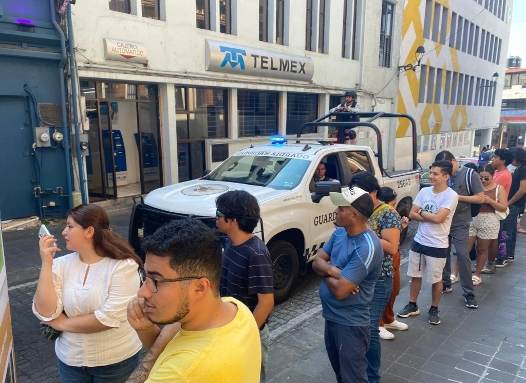 Elementos de la Guardia Nacional vigilan mientras ciudadanos realizan la fila para votar en la casilla especial instalada en el Palacio de Gobierno, en Jalapa, Veracruz, el 2 de junio de 2024. Foto Enrique Méndez