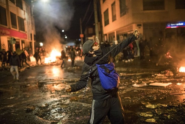 Enfrentamiento entre manifestantes y policías durante protestas en Bogotá. Foto Ap