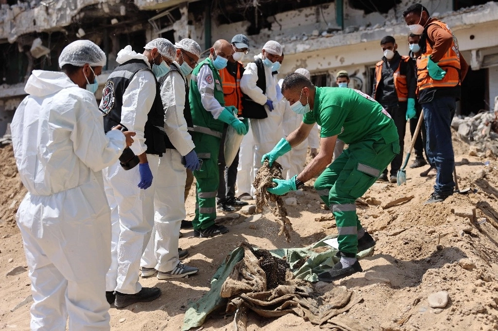 Forenses palestinos recuperan restos humanos en el Hospital Al Shifa, en Gaza, en imagen del 8 de abril pasado. Foto Afp 
