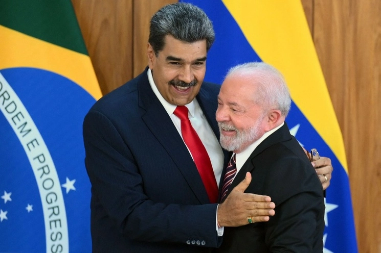 El mandatario de Brasil, Luiz Inácio Lula da Silva, recibió ayer con honores a su par de Venezuela, Nicolás Maduro, y juntos anunciaron el inicio de una “nueva época” de la relación. El presidente anfitrión enfatizó que buscará reactivar la región con sus homólogos de América del Sur: “hay que entender que es necesario colaborar en bloque para superar los problemas, más allá de las diferencias ideológicas”. Afirmó que sueña con crear una moneda para el comercio internacional diferente al dólar. Foto Afp 




