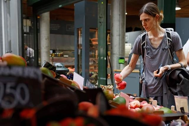 Una mujer compra alimentos en un mercado en la ciudad de Londres, Reino Unido. Foto Afp