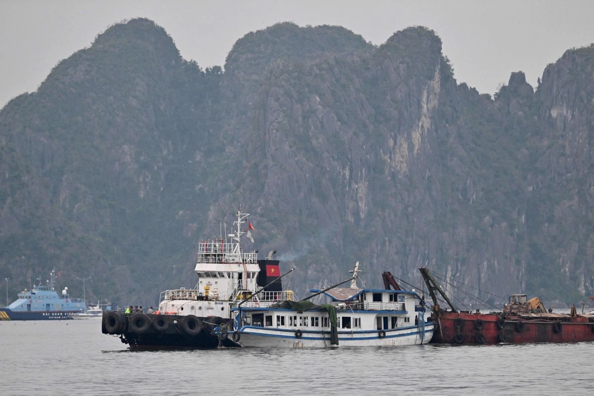 El barco turístico (C) que naufragó es remolcado de regreso al puerto en la bahía de Ha Long, provincia de Quang Ninh, el 20 de julio de 2025. Foto