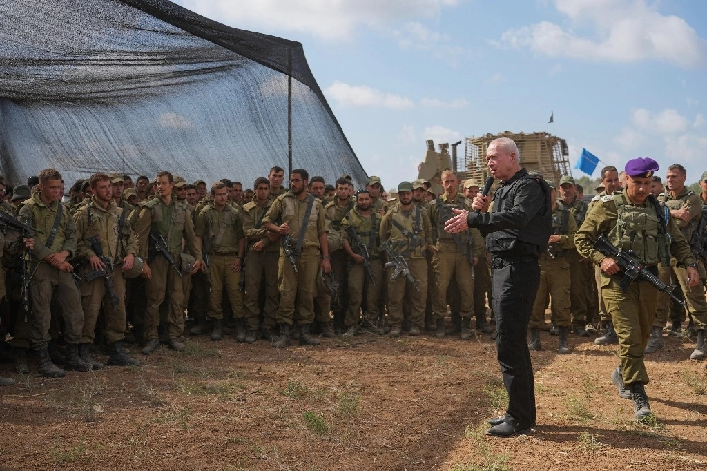 El ministro de Defensa de Israel, Yoav Gallant, habla con soldados israelíes en un área de preparación cerca de la frontera con la Franja de Gaza en el sur de Israel, el jueves 19 de octubre de 2023. Foto Ap