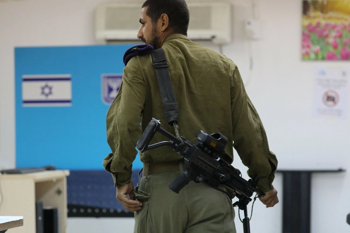 Un soldado israelí acude a emitir sus voto anticipado en las elecciones generales al sur de Israel, cerca de la Franja de Gaza. Foto Afp 
