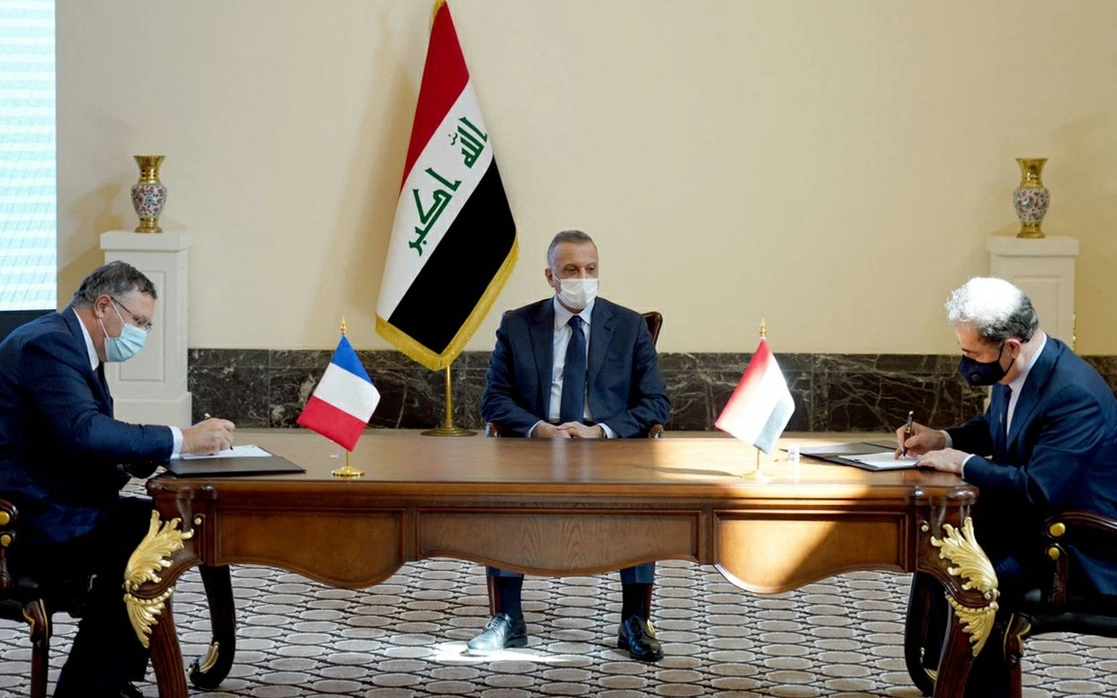 El ministro de petróleo iraquí Ihsan Abdul-Jabbar Ismail (der.) y el jefe de la compañía de energía francesa TotalEnergies, Patrick Pouyanne (izq.) durante la firma de  contrato para invertir en petróleo, gas y producción de energía solar en Irak. Foto Afp