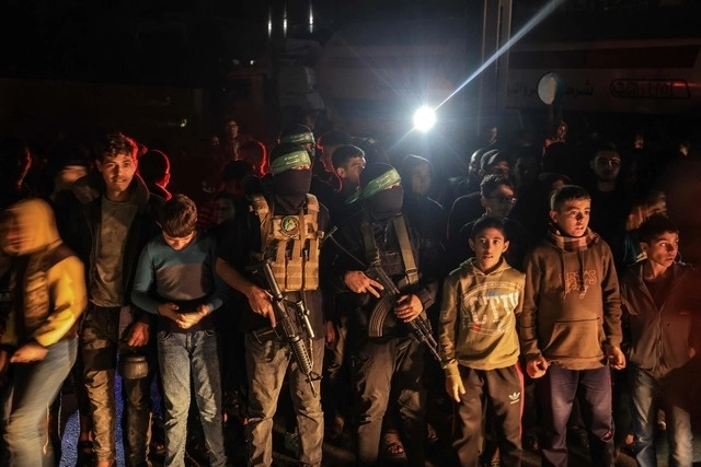 Niños y militantes del ala militar del movimiento palestino Hamas, Brigadas Qassam, en Khan Yunis, al sur de la franja de Gaza, el 29 de noviembre de 2023. Foto Afp 