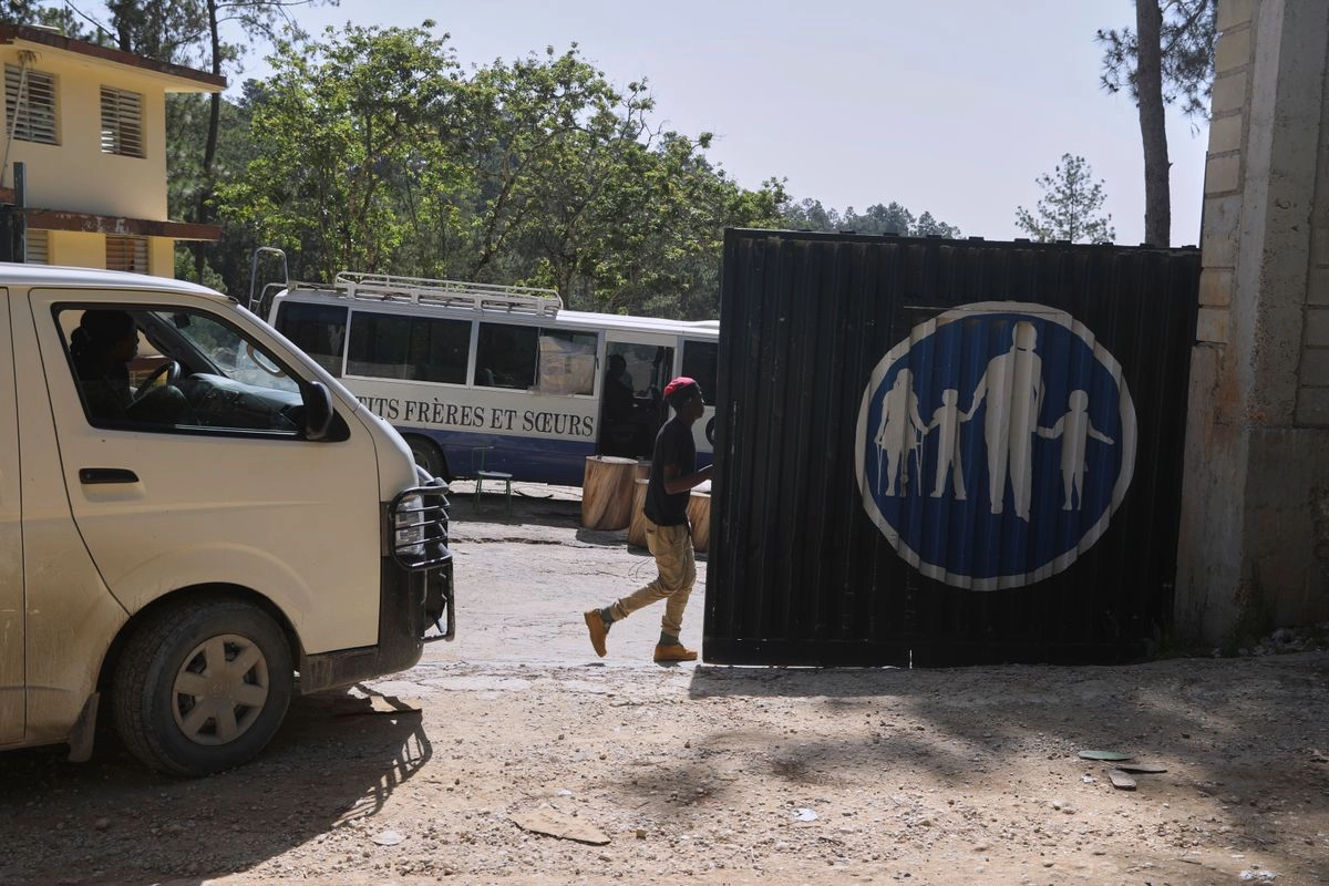 Los trabajadores ingresan al orfanato Saint-Helene en el barrio de Kenscoff en Puerto Príncipe, Haití, el 4 de agosto de 2025, el día después de que hombres armados irrumpieran en la propiedad y secuestraran a ocho personas.