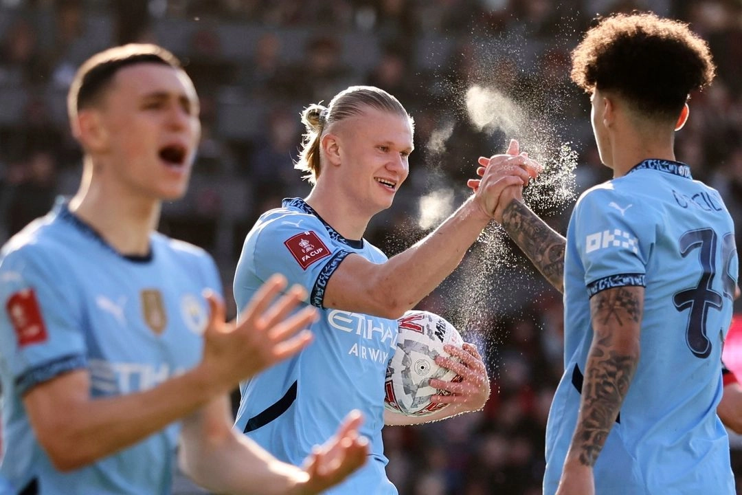 Erling Haaland, del Manchester City (centro), celebra con Nico O'Reilly (derecha), del Manchester City, tras anotar el primer gol de su equipo durante el partido de cuartos de final de la Copa FA inglesa entre el Bournemouth y el Manchester City en el estadio Vitality de Bournemouth, Inglaterra, el domingo 30 de marzo de 2025. Foto