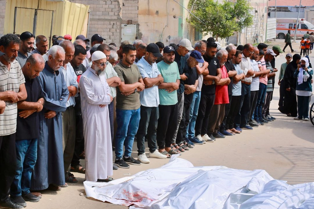 Palestinos rezan durante el funeral de sus familiares tras ataques israelíes, en Khan Yunis, en el sur de la Franja de Gaza, el 16 de junio de 2025. 