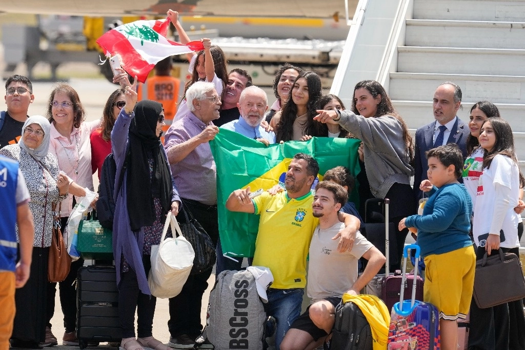 Los brasileños que estaban en Líbano posan para una foto con el presidente brasileño Luiz Inácio Lula da Silva, en el centro, mientras desembarcan después de que la Fuerza Aérea Brasileña los rescatara en medio de ataques aéreos israelíes, en la base de la Fuerza Aérea en Guarulhos, área metropolitana de Sao Paulo, Brasil, el 6 de octubre de 2024. Foto Ap