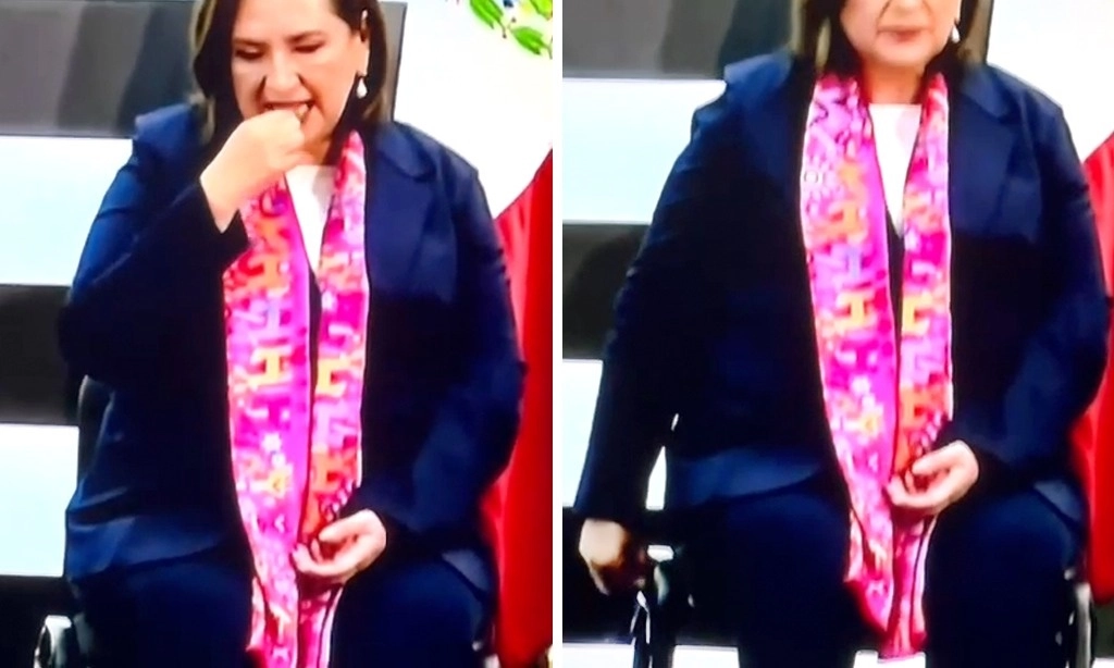 Imagen de Xóchitl Gálvez cuando se saca aparentemente un chicle de la boca y lo pega en una silla del INE, momentos antes de rendir protesta como candidata presidencial de la coalición Fuerza y Corazón por México. Captura del video del INE 