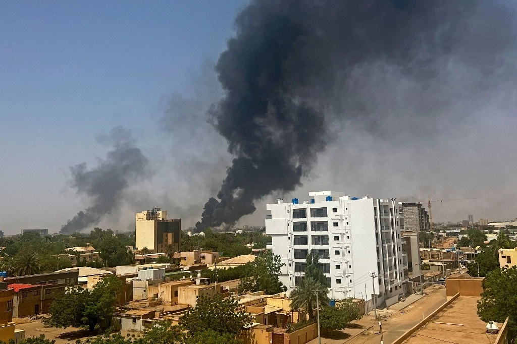 Humo se eleva sobre edificios residenciales en Jartum, ayer 16 de abril, mientras los combates en Sudán se intensificaban por segundo día en batallas entre generales rivales. Foto por AFP