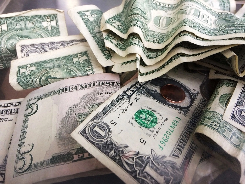 Un frasco de propinas contiene billetes de uno y cinco dólares, el 6 de septiembre de 2017 en Nueva York. Foto Ap