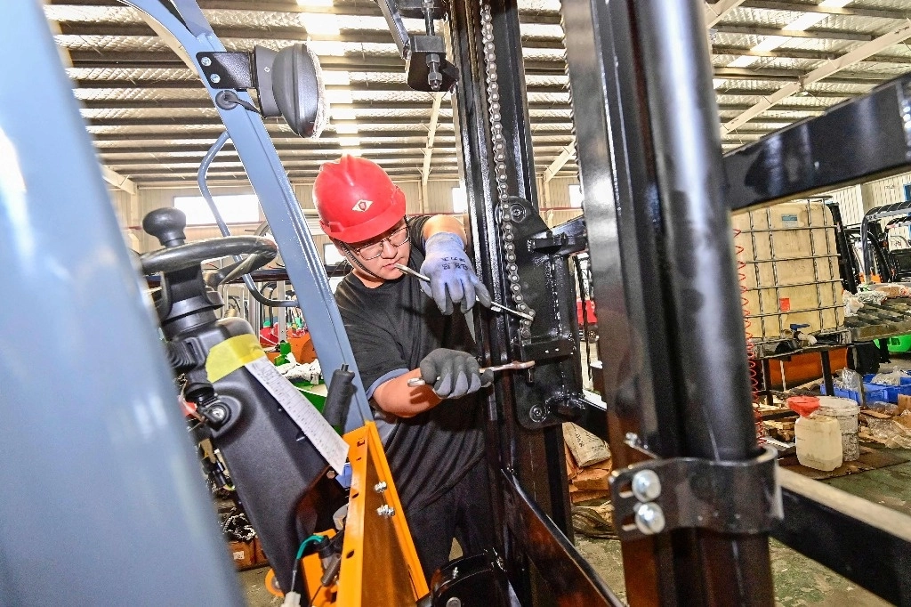 Un empleado trabaja en una carretilla elevadora en una fábrica en Qingzhou, en la provincia oriental china de Shandong, el 18 de octubre de 2023. Foto Afp