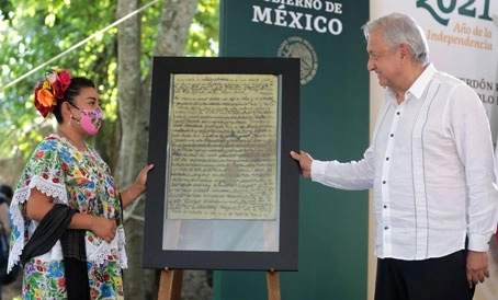 El presidente Andrés Manuel López Obrador hace entrega de la Proclama de la Cruz Parlante a Ana Karen Dzib Poot, representante del pueblo maya, durante el acto en el cual se ofrecieron disculpas a los habitantes originarios del sureste nacional. Foto Presidencia