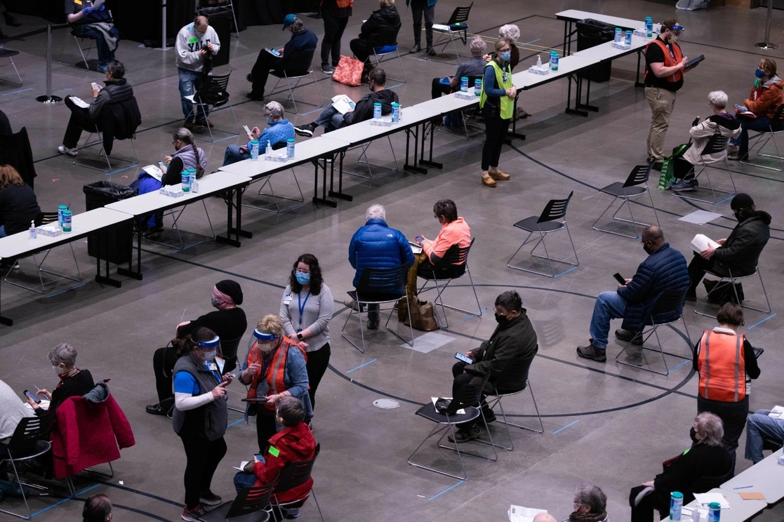 Receptores de la vacuna contra Covid-19 esperan posibles reacciones después de recibir su primera dosis, en el Centro de Reuniones de Amazon, en Seattle, Washington, el 24 de enero de 2021. Foto Afp 