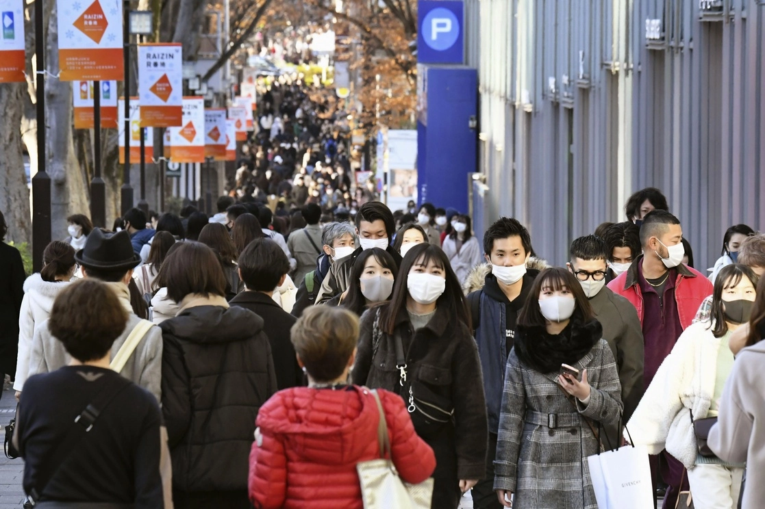 Ciudadanos japoneses caminan por la calle comercial Aoyama en Tokio este domingo 27 de diciembre de 2020. Foto Ap