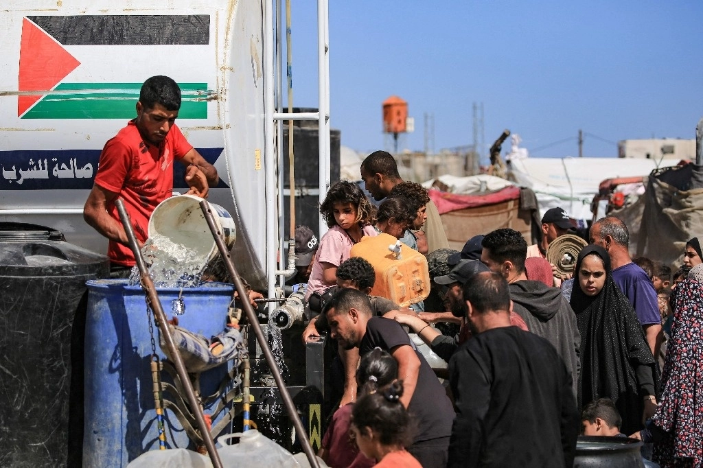 Palestinos desplazados van a buscar agua en Khan Yunis, en el sur de la Franja de Gaza, en medio del conflicto en curso entre Israel y el movimiento Hamás. Foto Afp