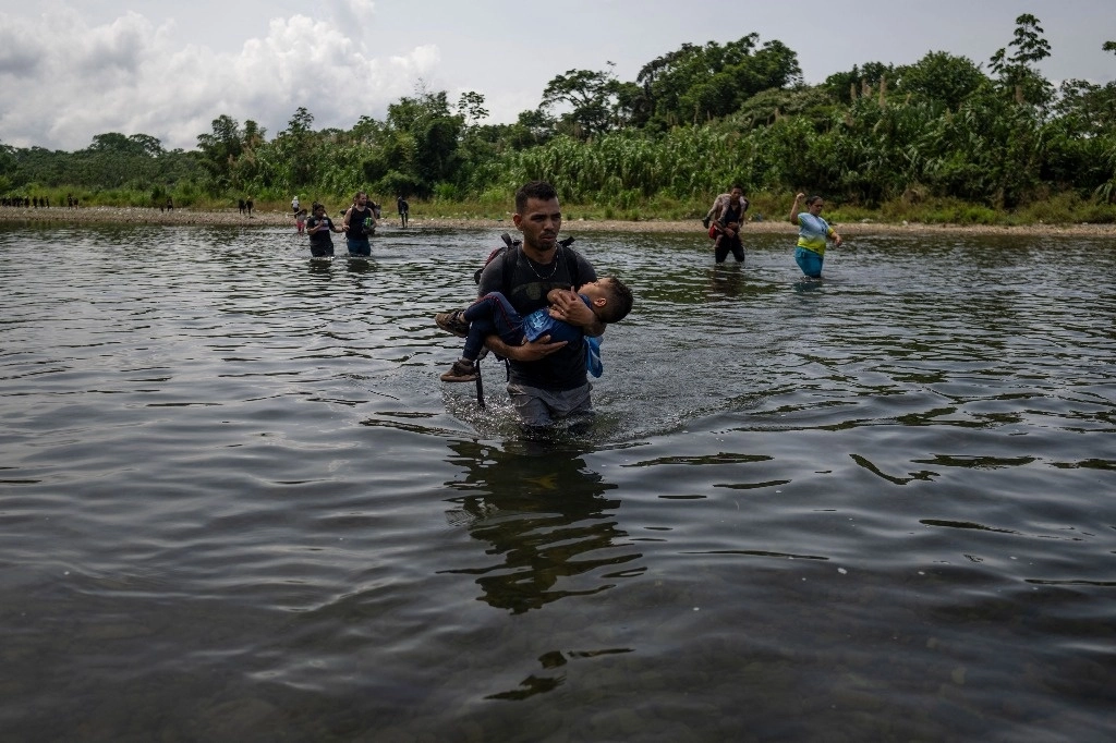 Migrantes cruzan el río Turquesa cerca de la aldea de Bajo Chiquito, el primer control fronterizo de la provincia de Darién en Panamá, el 22 de septiembre de 2023. Foto Afp 