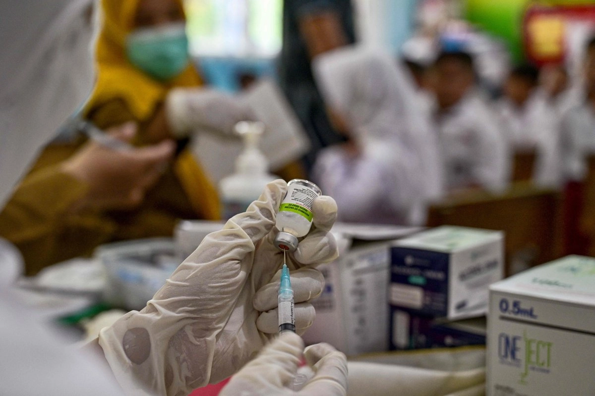 Un trabajador de salud colocando una vacuna para aplicar. Foto
