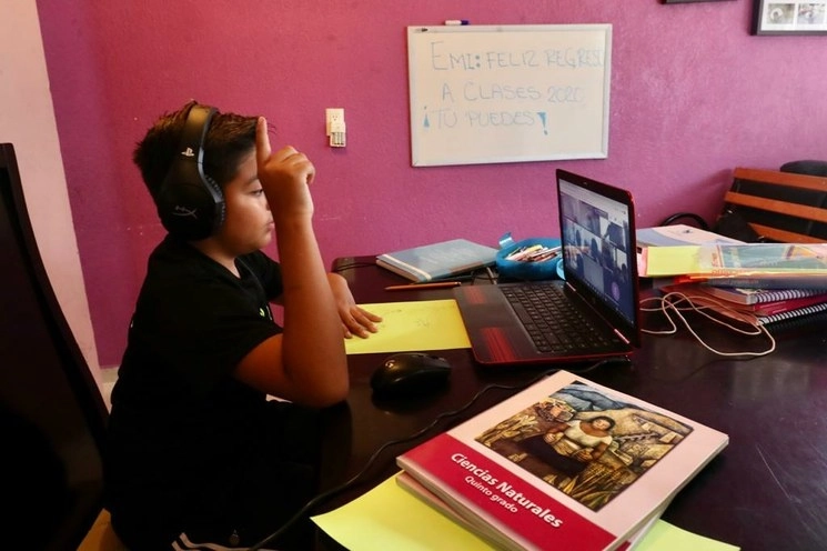 Un niño de primaria toma clases con su grupo a través de Zoom durante el primer día de clases a distancia. Foto Luis Castillo / Archivo
