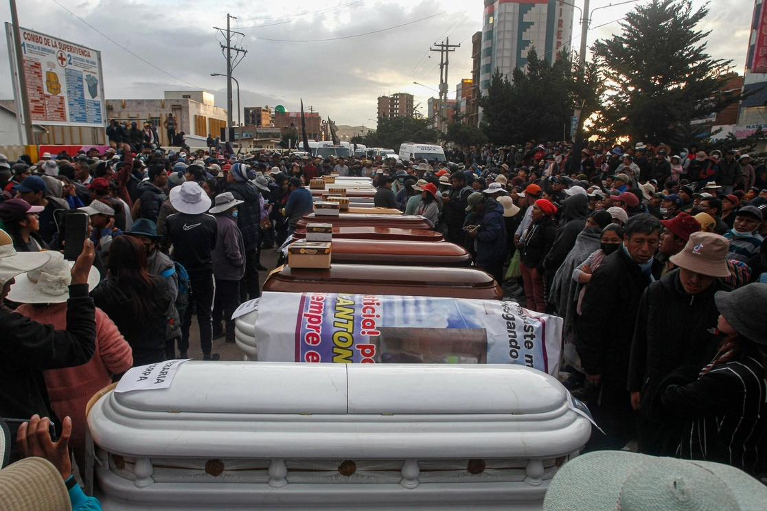 Familiares de las víctimas de los enfrentamientos con la policía peruana esperan con ataúdes vacíos frente a la morgue del hospital Carlos Monge Medrano en Juliaca, en el sur de Perú, mientras el gobierno anunció un toque de queda en la región sureña de Puno en un intento por para reprimir las protestas violentas. Foto Afp