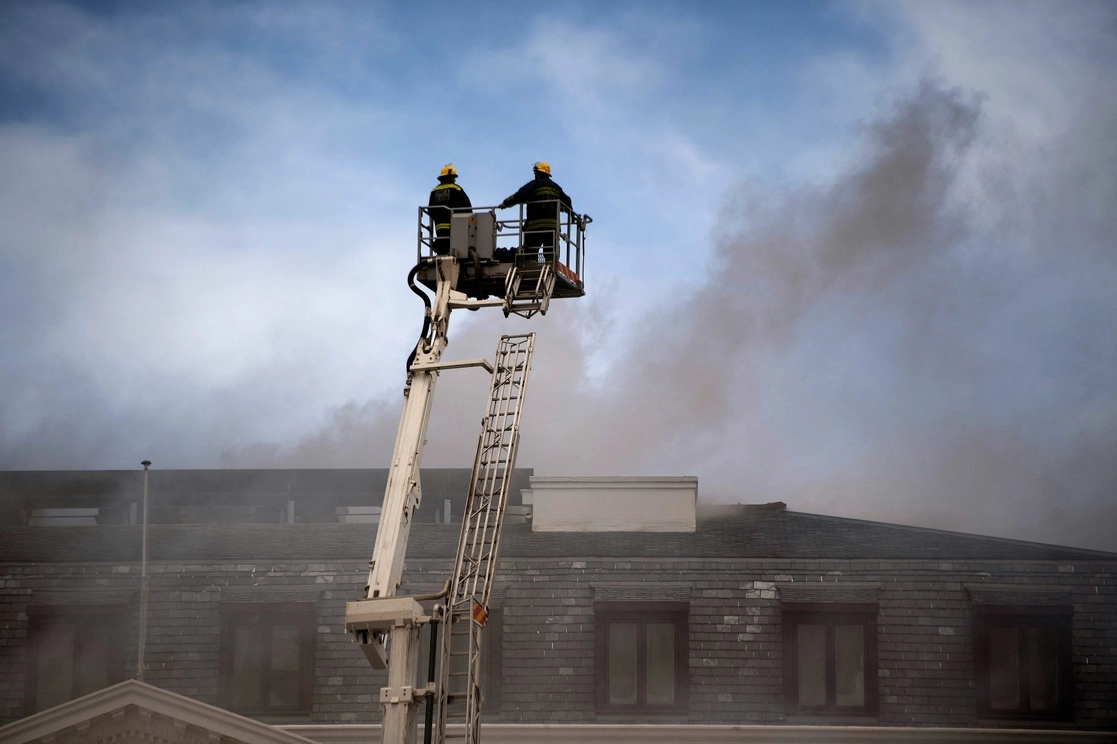 Bomberos intentan sofocar el incendio desatado en la sede del Parlamento sudafricano en Ciudad del Cabo, el 2 de enero de 2021. Foto Afp 