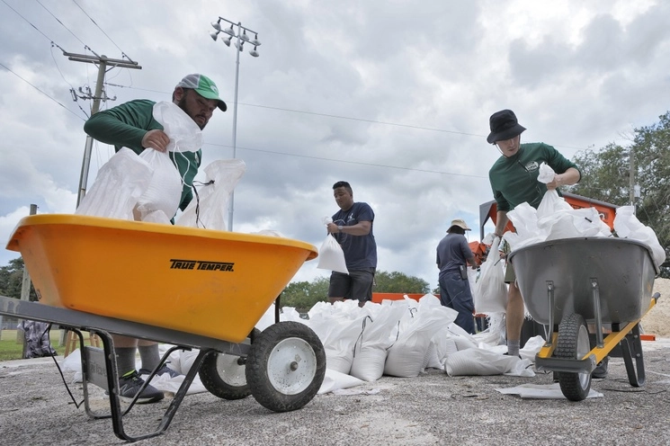 Habitantes de Tampla, Florida, se preparan con costales de arena ante la llegada de la tormenta tropical ‘Idalia’, el 28 de agosto de 2023. Foto Ap 