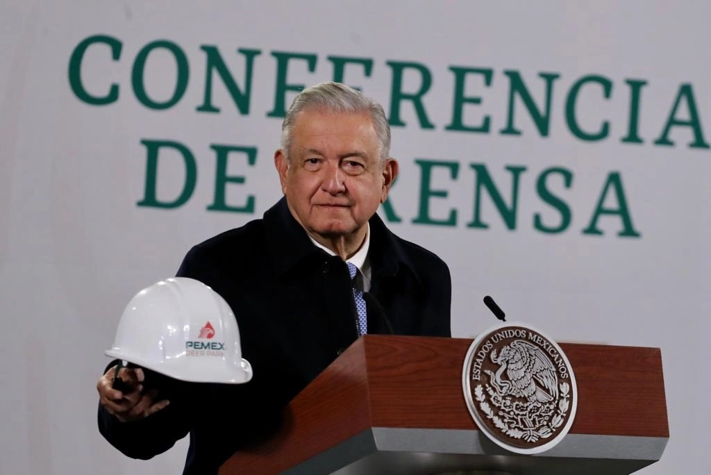 El presidente Andrés Manuel López Obrador muestra un casco con el logotipo de Pemex y la recién adquirida refinería estadunidense Deer Park, durante la conferencia matutina del 22 de diciembre de 2021. Foto Roberto García Ortiz