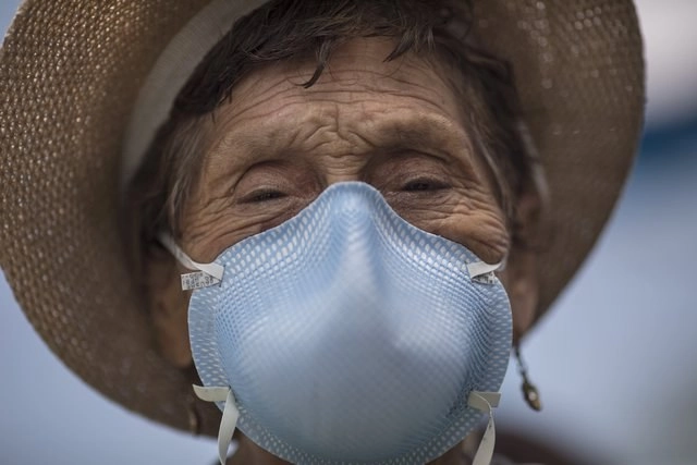 Una mujer de 92 años sale de una clínica, donde fue vacunada contra neumonía, como parte de una campaña de vacunación masiva para adultos mayores en Perú. Foto Ap