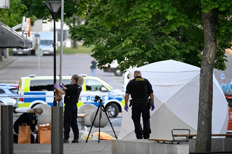 Oficiales forenses de la policía trabajan en la escena de un tiroteo en el centro comercial Farsta en el sur de Estocolmo el 10 de junio de 2023. Foto Afp