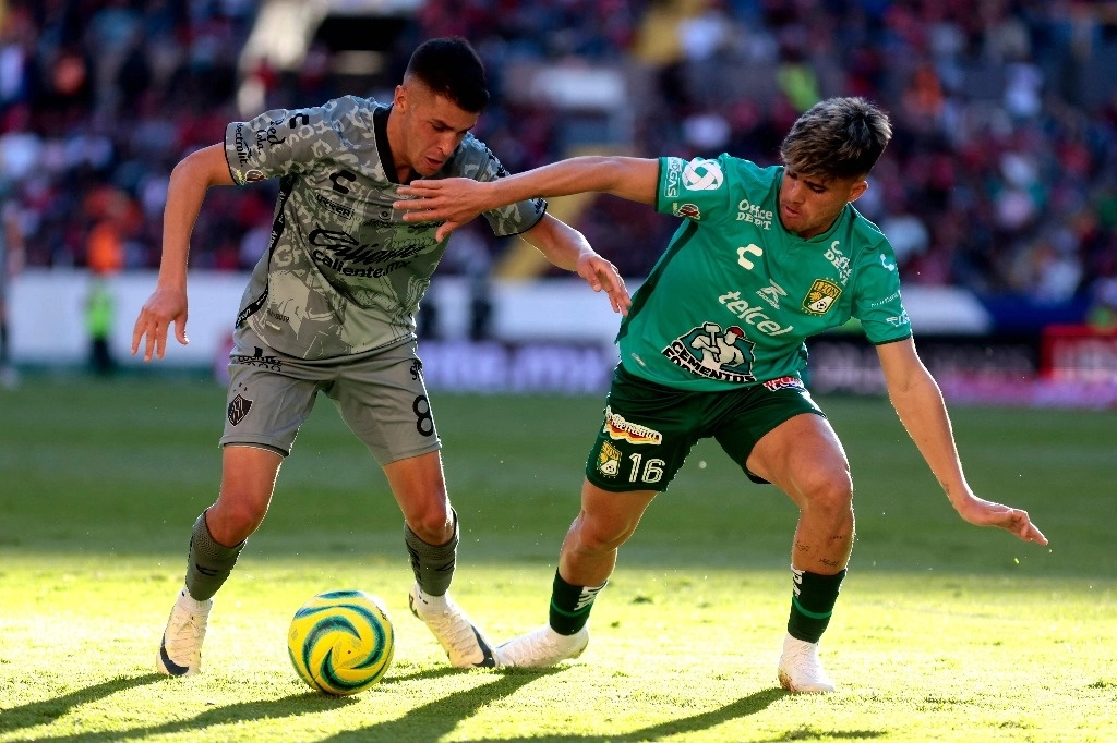 El centrocampista argentino del Atlas Mateo García (L) compite por el balón con el delantero uruguayo de León Alan Medina durante su partido de fútbol del torneo Clausura mexicano, en el estadio de Jalisco, en Guadalajara, estado de Jalisco, México, 18 febrero 2024. Foto Afp