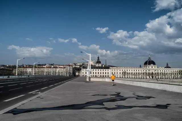 Un hombre trota entre las calles desiertas de Lyon, Francia. Foto Afp
