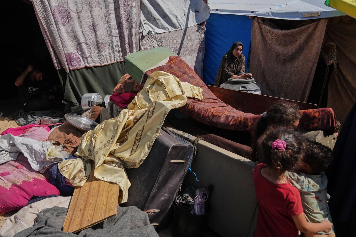 Una mujer permanece junto a sus pertenencias después de llegar desde el norte de Gaza a un campamento para palestinos desplazados en Muwasi, un área que Israel ha designado como zona segura, en Khan Younis, al sur de la Franja de Gaza, el lunes 29 de septiembre de 2025. Foto